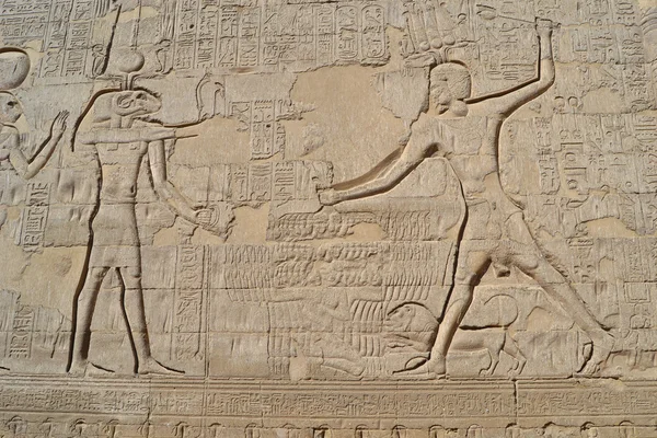 Hieroglyphen-Schnitzereien an einer ägyptischen Tempelwand lizenzfreie Stockbilder