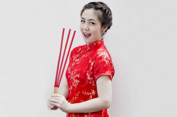 Kinesiska ung kvinna med tradition kläder håller joss pinnar( — Stockfoto