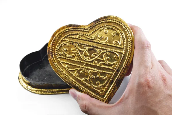 Händer som håller gyllene hjärta — Stockfoto