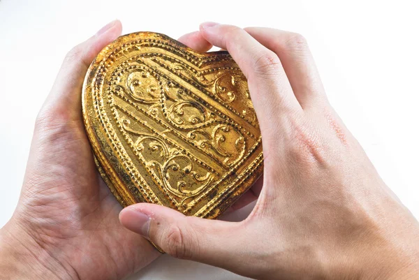 Hands holding golden heart — Stock Photo, Image