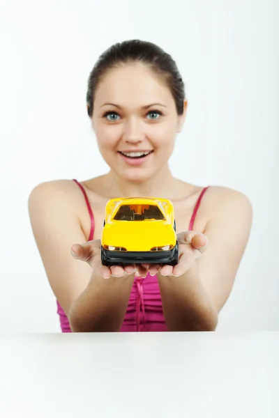 Girl with a toy machine — Stock Photo, Image