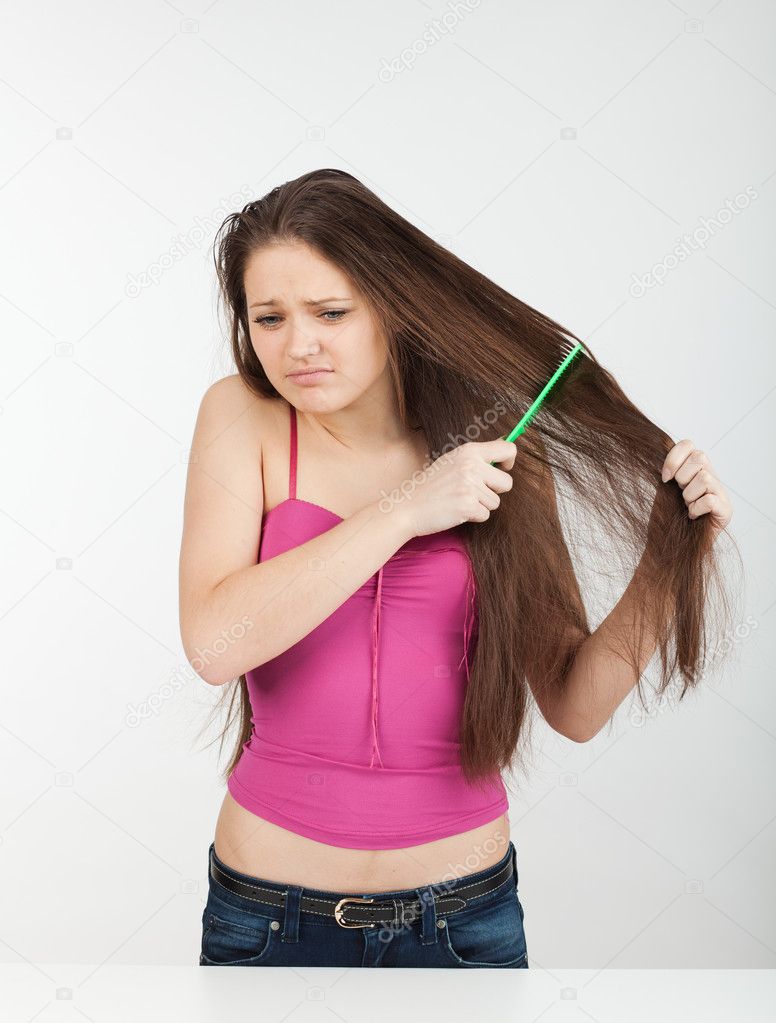 Girl combs her hair