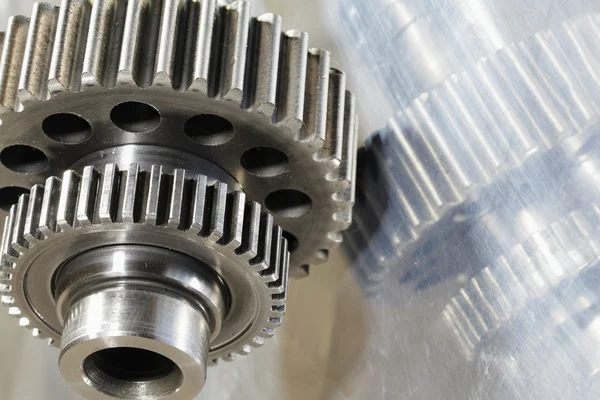 Titanium gears mirrored in steel — Stock Photo, Image