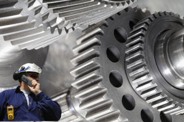 Metal worker with giant machinery clipart