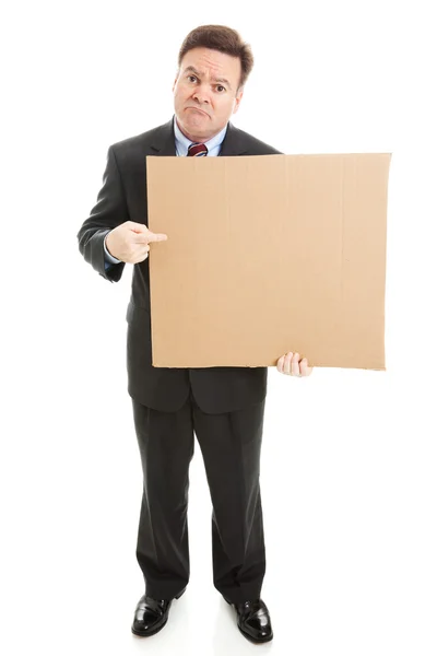 Грустный бизнесмен с картонным знаком — стоковое фото