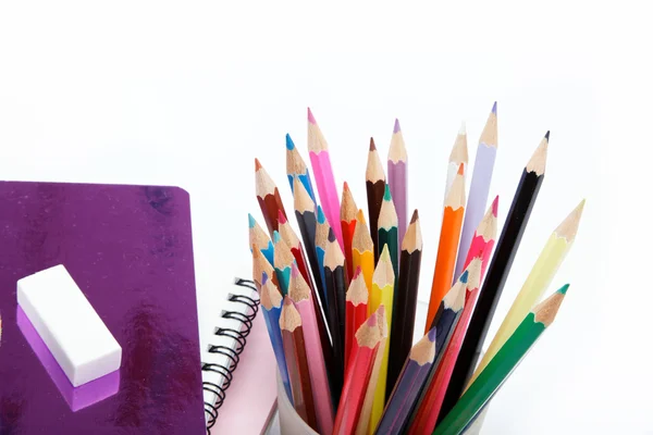 Coloured pencils and notebooks on a white background. — Stock Photo, Image