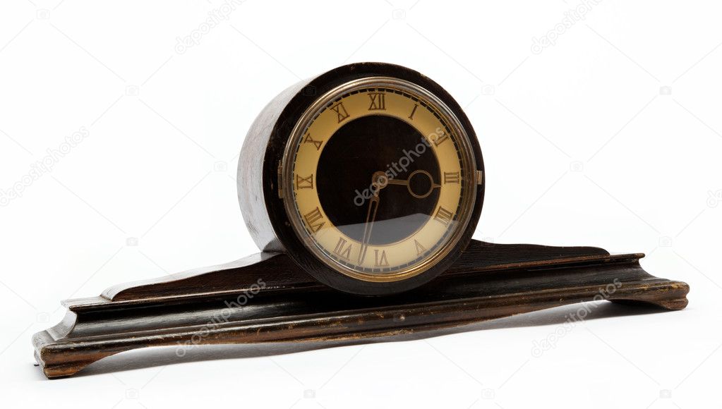 Antique wooden table clock on a white background.