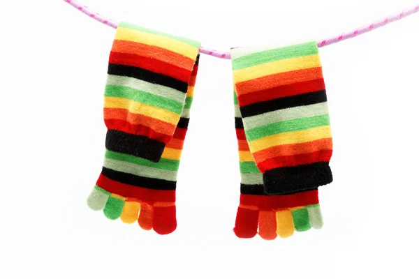 Разноцветный веселый носок висит на веревке . — стоковое фото