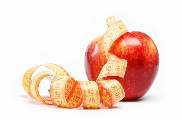 Red apple and measuring tape on a white background. — Stock Photo, Image