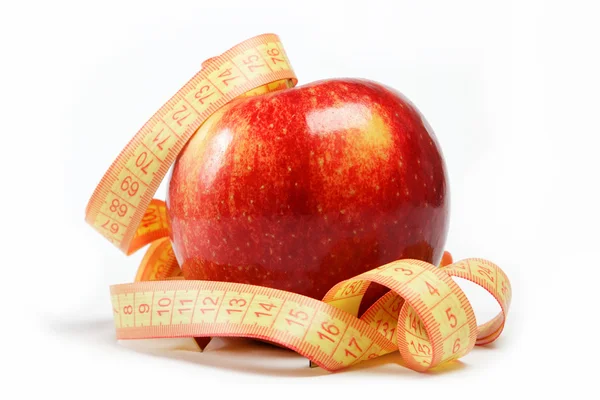Červené jablko a měřicí pásky na bílém pozadí. — Stock fotografie