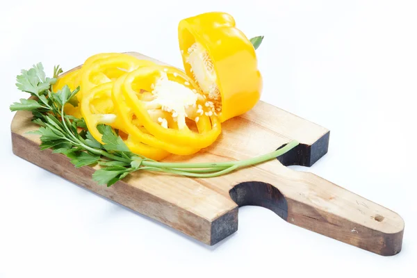 Yellow pepper and parsley on a wooden board isolated. — Stock Photo, Image