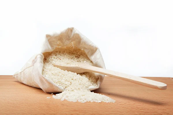 Rice on a wooden table. — Stock Photo, Image