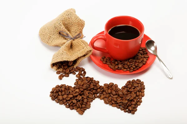 Two hearts made ​​from coffee beans around a cup of coffee o — Stock Photo, Image