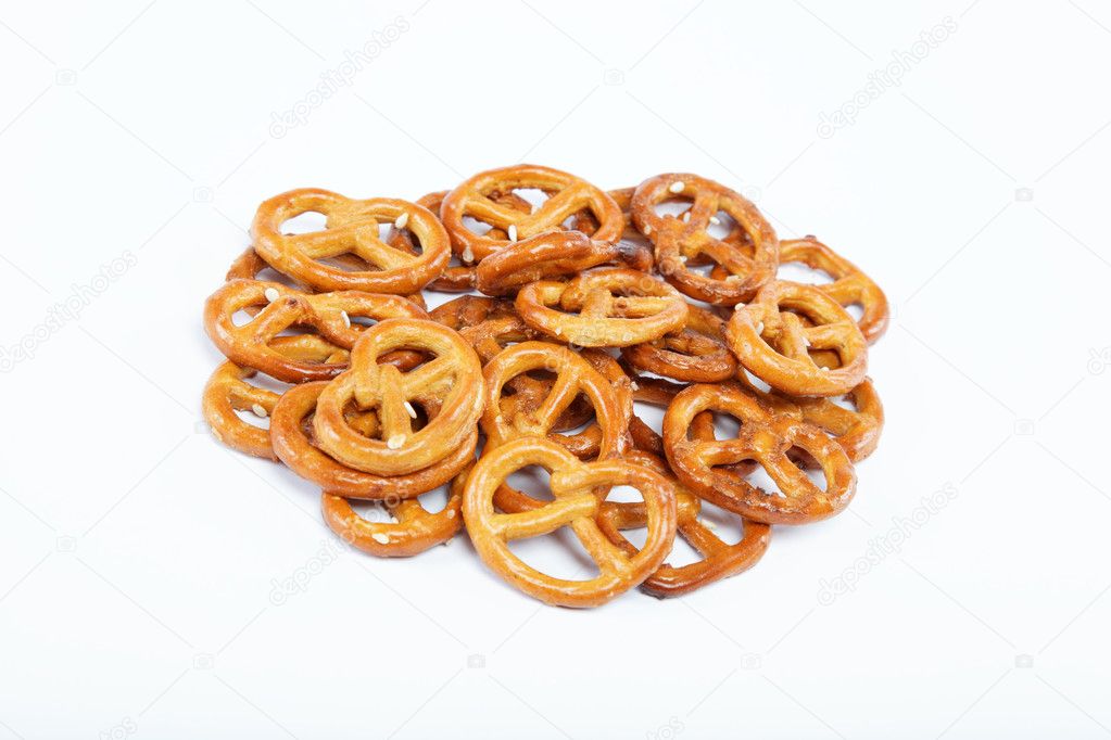 A handful of crunchy pretzels on a white background.