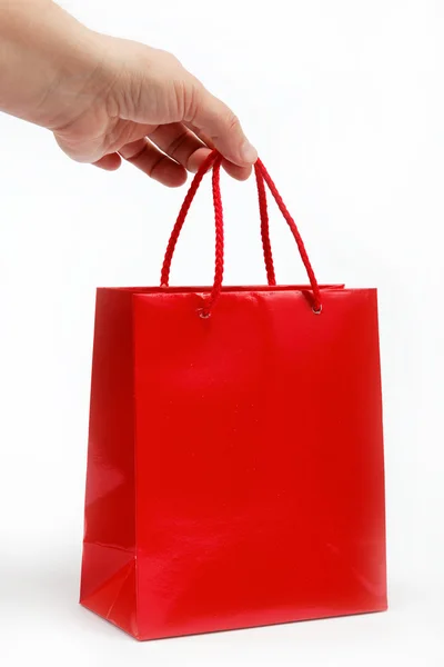Kırmızı hediye çanta ve narenciye beyaz zemin üzerine. — Stok fotoğraf