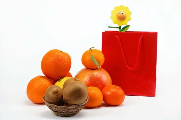 Red Gift Bag and citrus fruits on a white background. — Stock Photo, Image