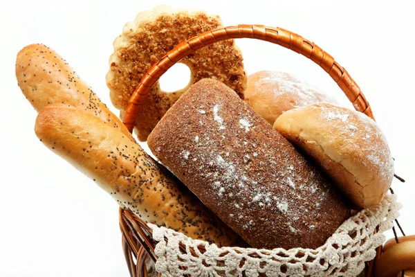 Fresh bread in a basket on a white background. — Stock fotografie