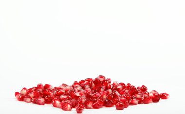 Pomegranate seeds on a white background clipart