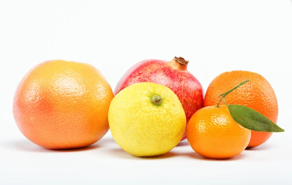 stock image Pomegranates and citrus fruits isolated on a white background.