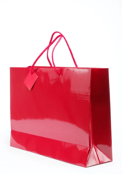 Rote Geschenktüte auf weißem Hintergrund. — Stockfoto