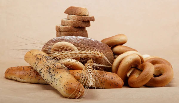 Fresh bread on a light brown background. — Stock Photo, Image
