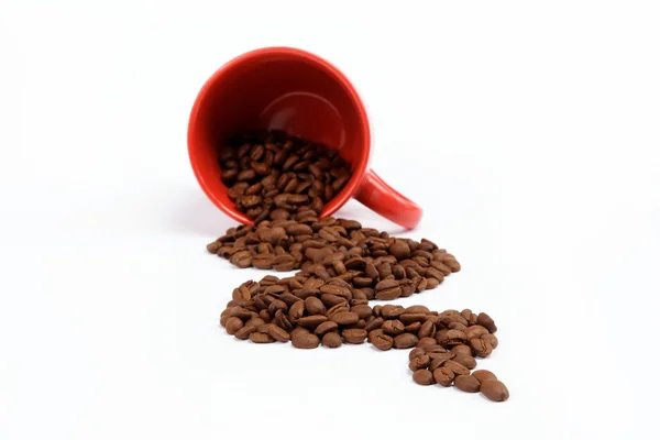 Flow beans from an overturned cup on a white background. — Stock Photo, Image