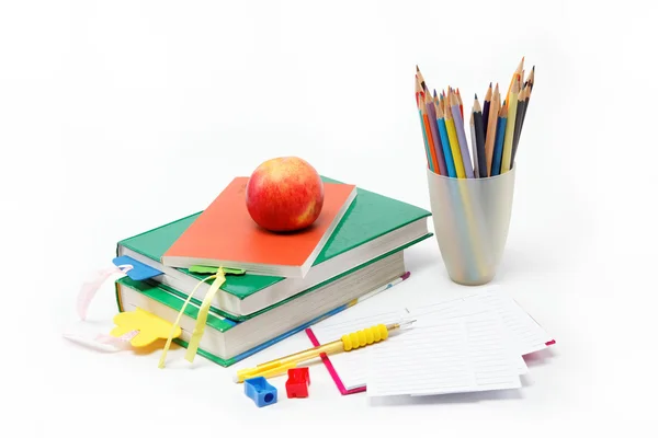 School supplies: books, notebook, pens, pencils, an apple on a w — Stock Photo, Image