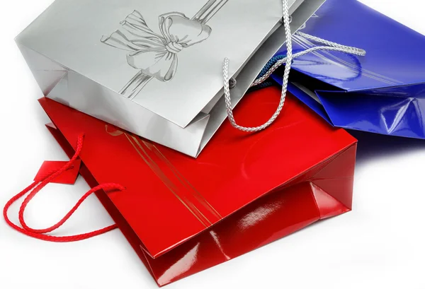 Red, blue and gray gift bags on a white background. — Stock Photo, Image