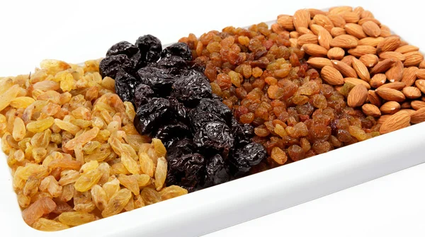 Mixed nuts and dried fruits. Almonds, raisins and prunes. — Stock Photo, Image