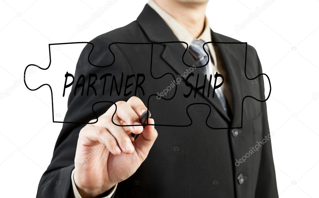 Businessman drawing partnership puzzle pieces