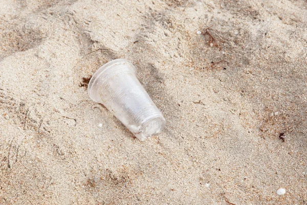 Garbage plastic glass on the beach — Stock Photo, Image