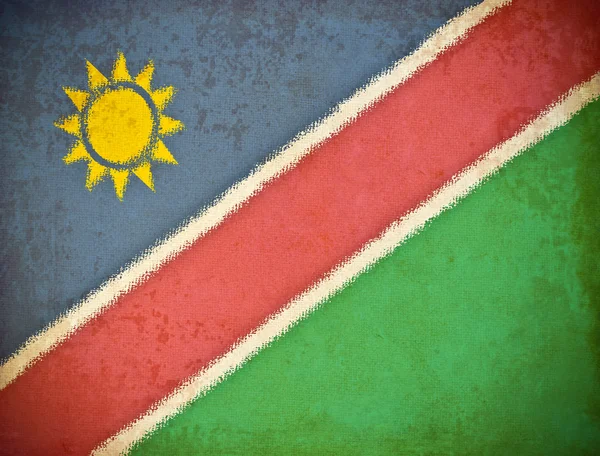 Старая гранж-бумага с фоном флага Намибии — стоковое фото