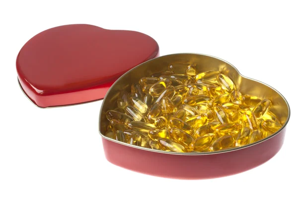 Yellow medicines in a heart — Stock Photo, Image