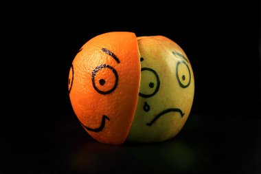 Sad apple with happy orange mask clipart