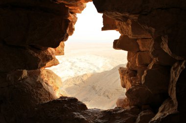 Ancient stone window of Masada fortress in Israel clipart