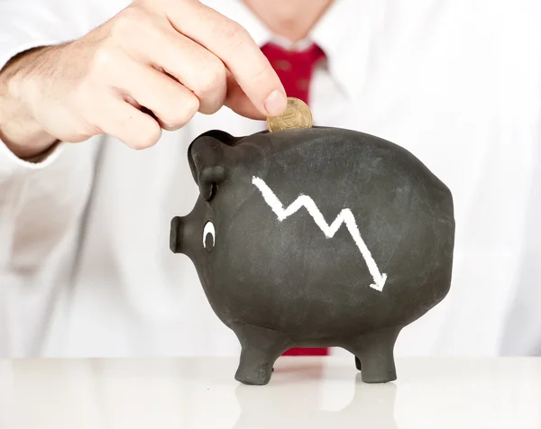 Businessman putting money on a piggy bank — Stock Photo, Image