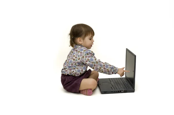 Little girl with a laptop — Stock Photo, Image