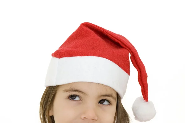 圣诞老人帽的小女孩 免版税图库图片