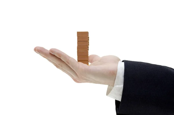 Businessman holding a pile of bricks — Stock Photo, Image
