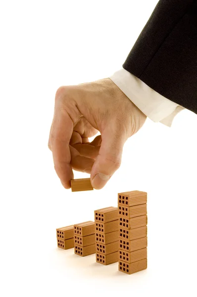 Businessman buiding a chart with bricks — Stock Photo, Image
