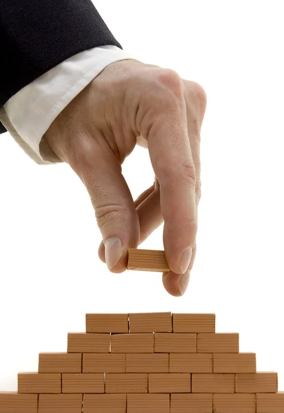 Businessman building a bricks wall — Stock Photo, Image