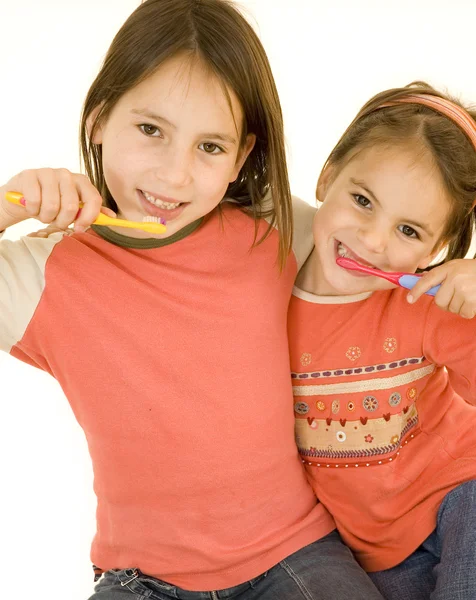 Two girls brushing his teeth — Stock Photo, Image