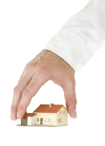 Üzletember kézzel egy kis ház — Stock Fotó