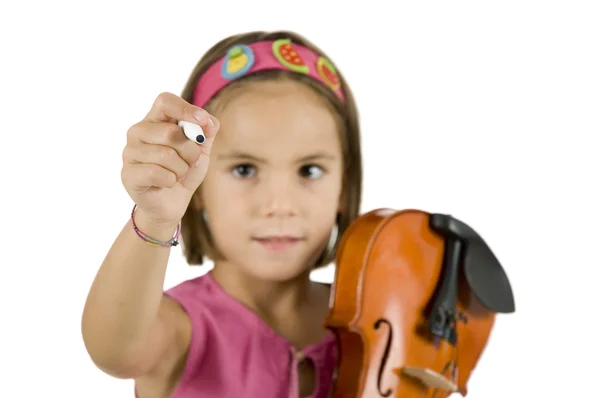 Kleines Mädchen, das mit einem Stift schreibt und eine Geige hält — Stockfoto