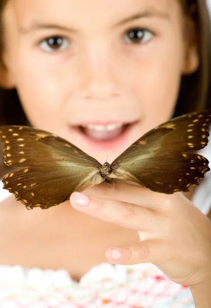 Little girl holding a butterfly — Stock Photo, Image