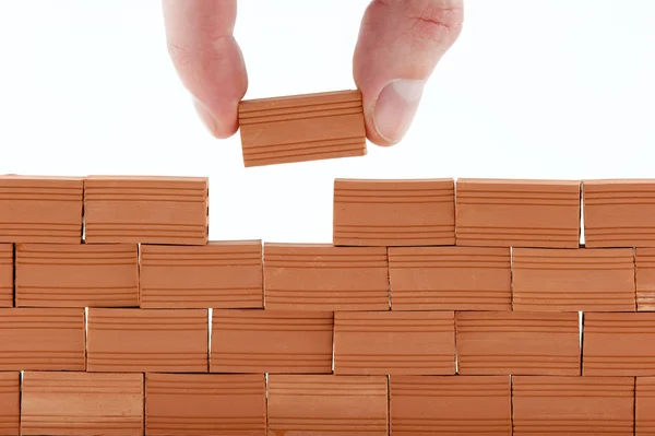 Putting a brick in a wall — Stock Photo, Image