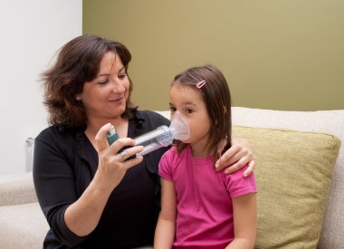 Mother using inhaler clipart