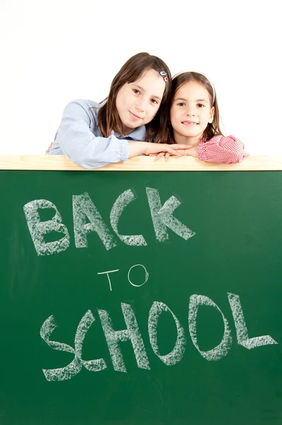Two girls with blackboard — Stock Photo, Image