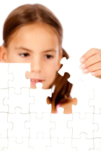 stock image Little girl assembling a blank puzzle