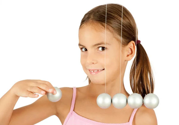 Young girl holding a pendulum ball — Stock Photo, Image